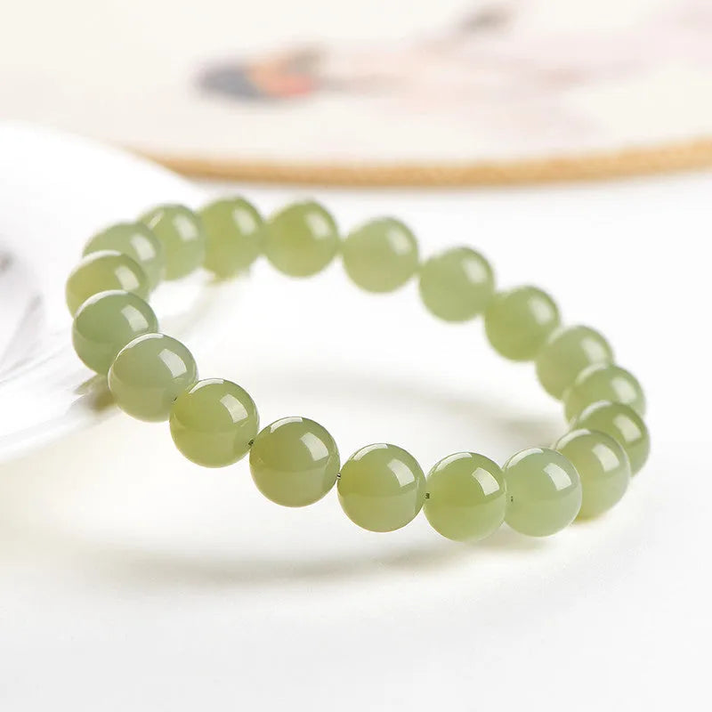 Hetian jade bead bracelet in ice-like clear colour on a white background.