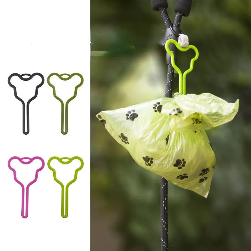 A hands-free dog poo bag holder with a fixed clip and adjustable Velcro strap attached to a dog lead.