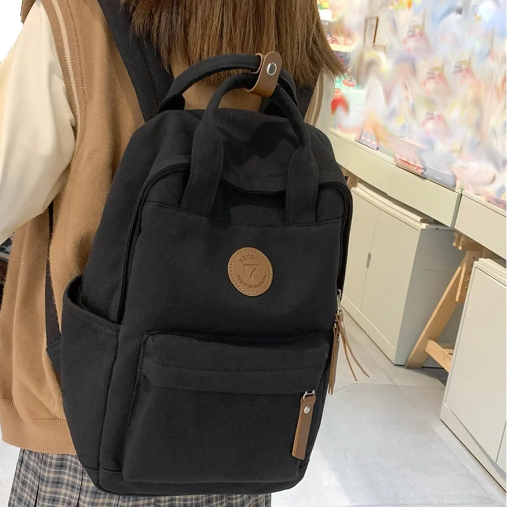 Black Oxford cloth backpack with curved shoulder straps and urban simplicity design