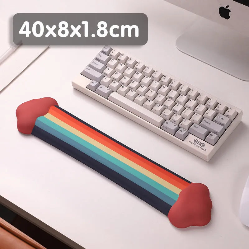 Silicone wrist rest and keyboard support mat set with printed white cloud pattern on a desk.