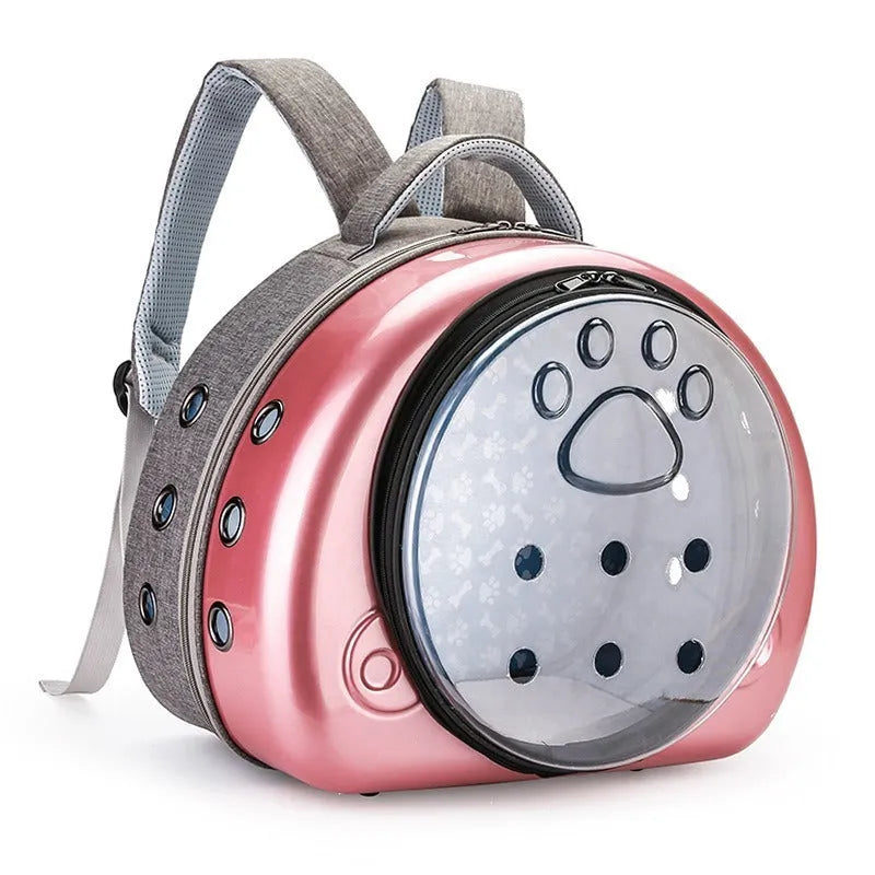 Transparent space capsule-style cat carrier bag with metallic-coloured front shell, on a white background.