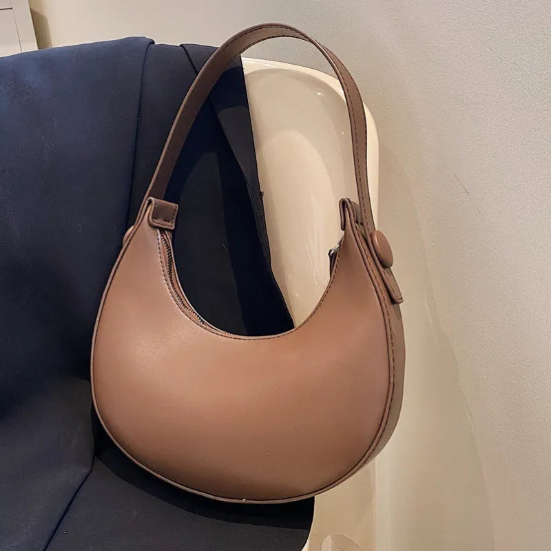Women's PU dumpling shape shoulder bag in retro brown with zipper compartment, measuring 21x20x6cm