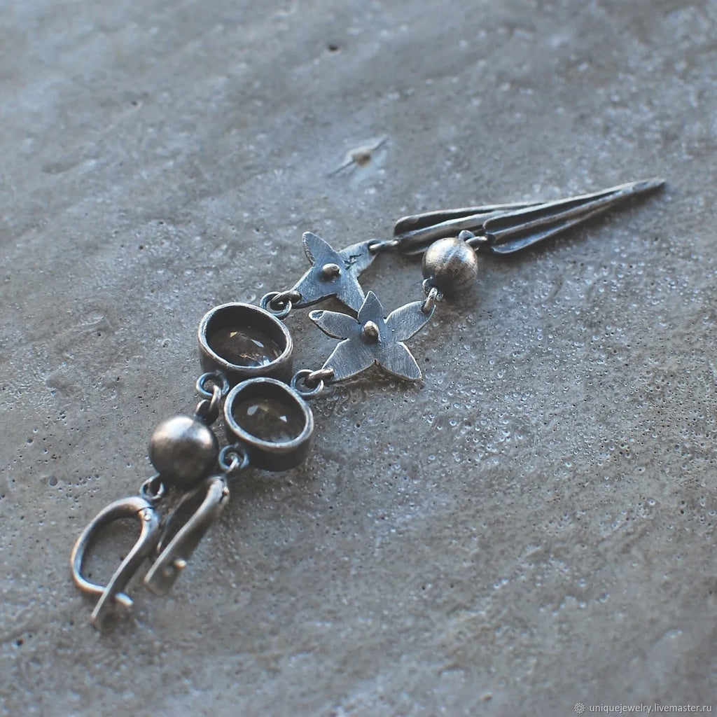 Long geometric XINGX design pendant earrings in antique silver tone with rhinestones.
