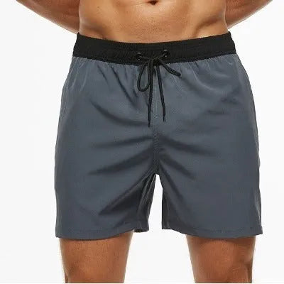 Men's blue drawstring shorts with stitched waistband and zippered pockets, shown for running and fitness use.