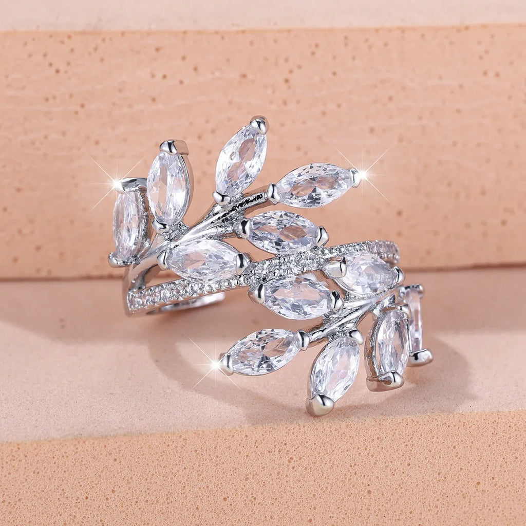 Adjustable horse eye zircon leaf ring in rose gold or platinum plating on a model's hand.