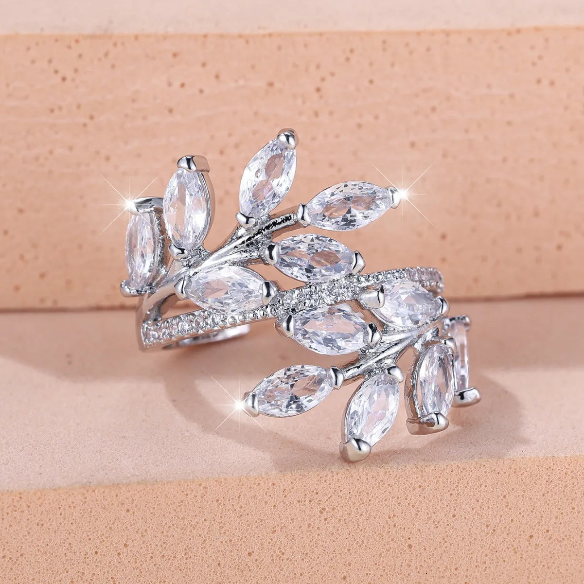Adjustable horse eye zircon leaf ring in rose gold or platinum plating on a model's hand.