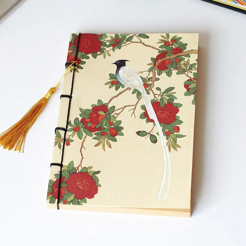 A5 antique wire-bound notebook with glossy embossed cover featuring a retro painting design, shown open.