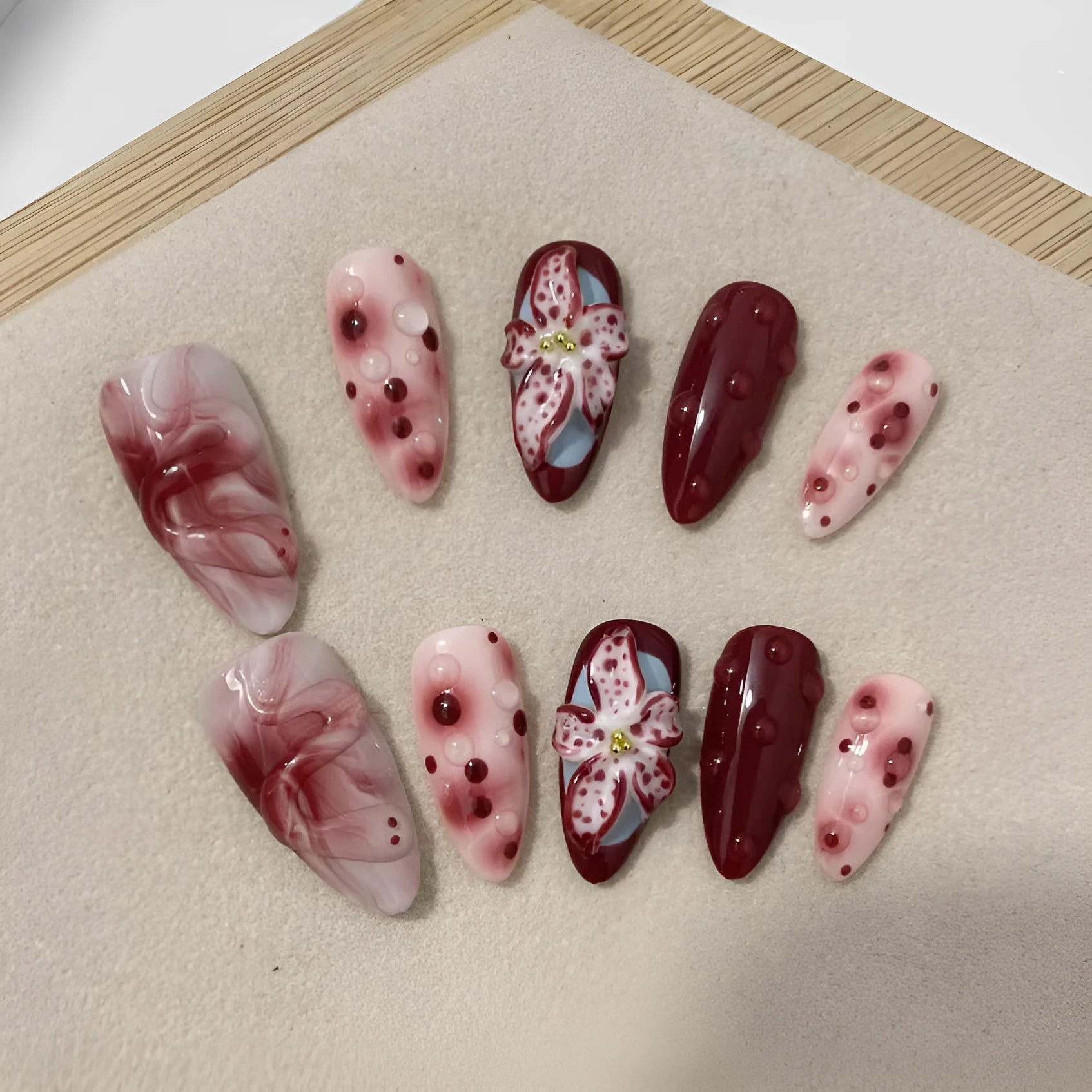 Almond-shaped false nails with hand-painted three-dimensional carved rose and starry sky patterns