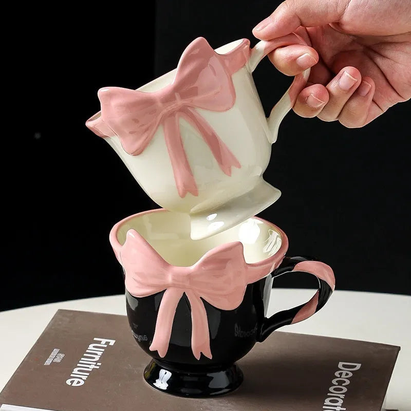 Ceramic mug with heart and bow design in black pink or white powder colour, 301-400ml capacity