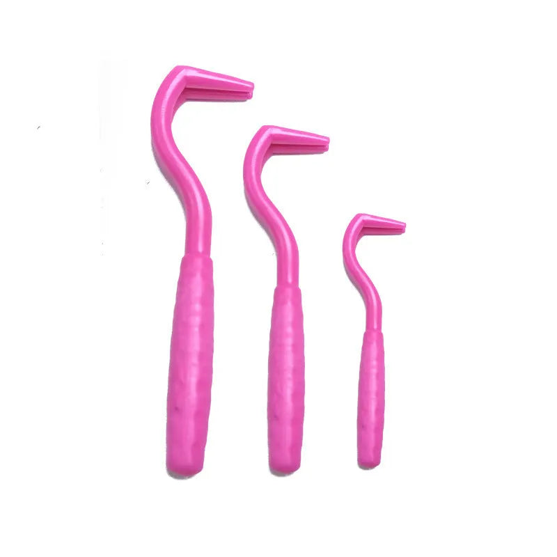 Set of three coloured ABS plastic tick hook removers for dogs on a white background.