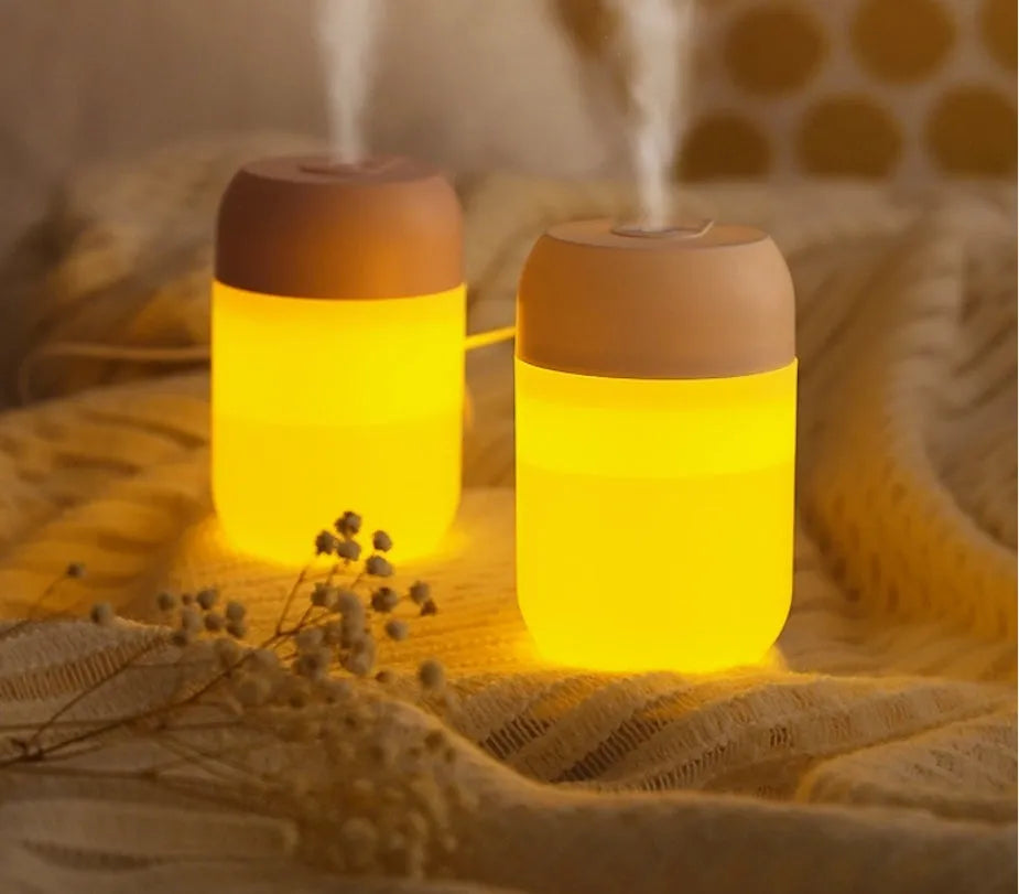 Small white cylindrical USB-powered humidifier on a desk