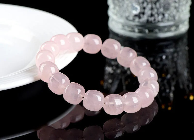 Pink crystal geometric barrel bead bracelet with 11-12mm beads on a wrist.