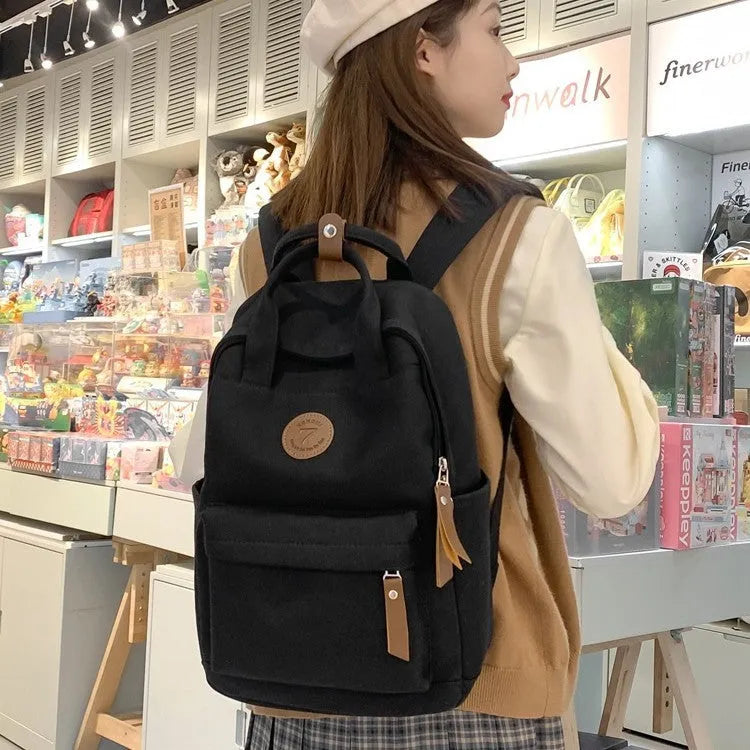 Black Oxford cloth backpack with curved shoulder straps and urban simplicity design