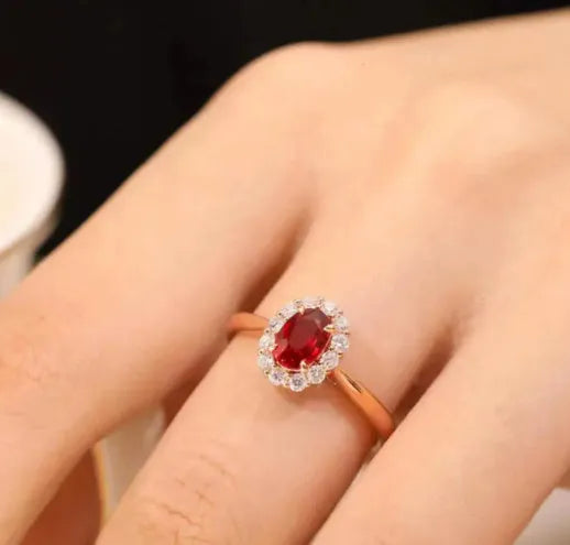 Women's sterling silver ring with gold pigeon design and red gemstone inlay on floral patterned band
