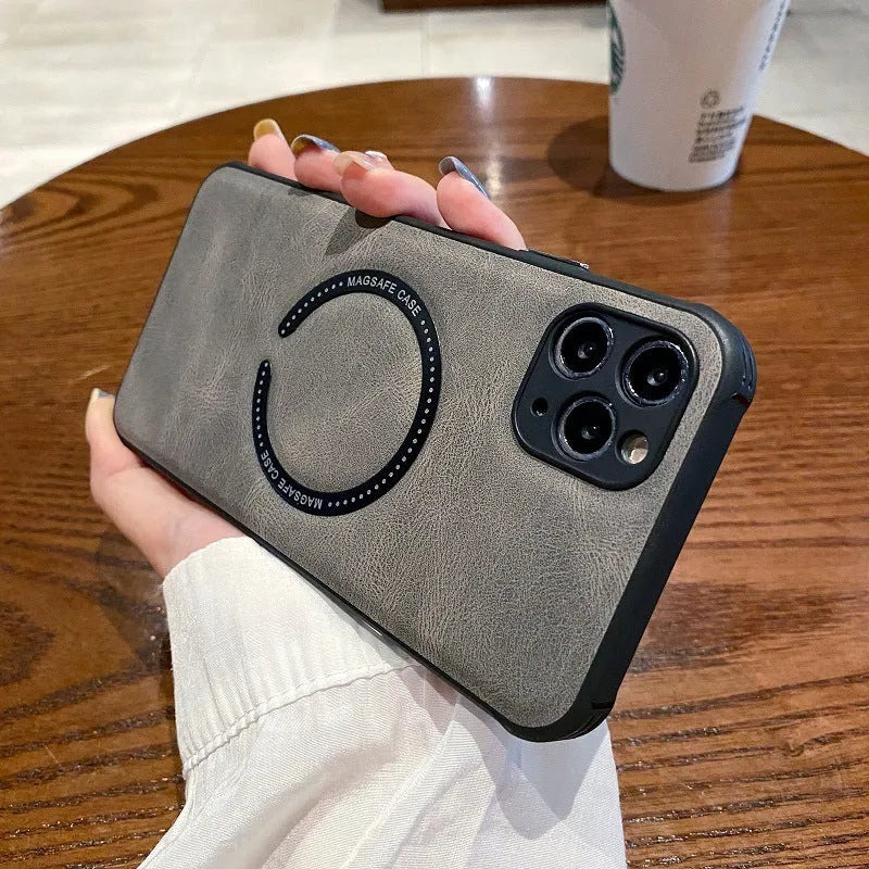 Black imitation leather magnetic charging case for Apple iPhone on a wireless charger.