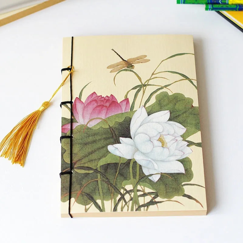 A5 antique wire-bound notebook with glossy embossed cover featuring a retro painting design, shown open.