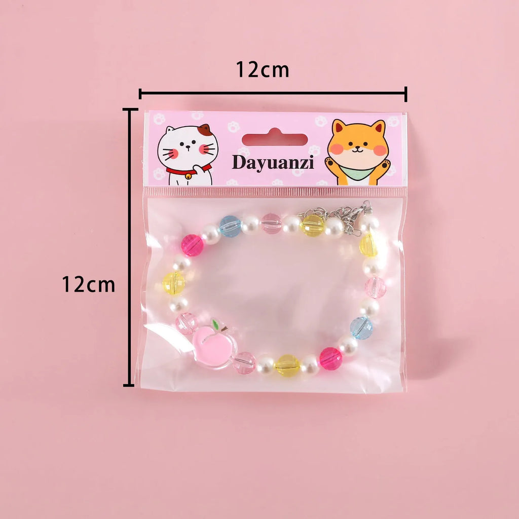 Colourful plastic pearl pet necklace for cats with adjustable sizing in rainbow, peach, and small flower patterns