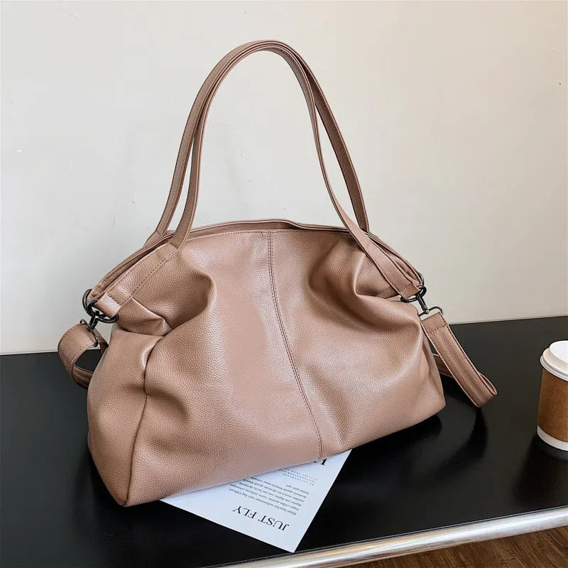 Large soft surface messenger bag in horizontal square shape with adjustable shoulder strap and zipper opening