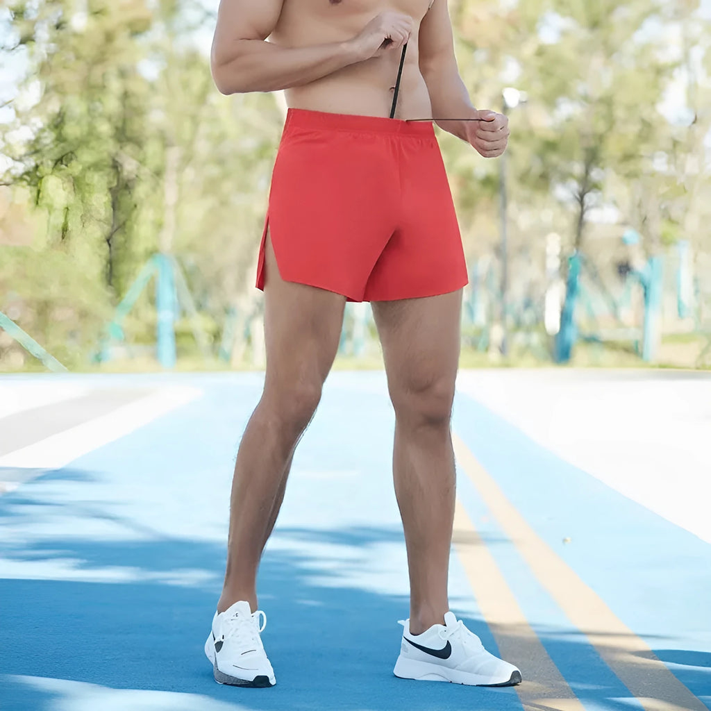 Men's red off-road running shorts with a high waist and loose fit, shown for athletic use.
