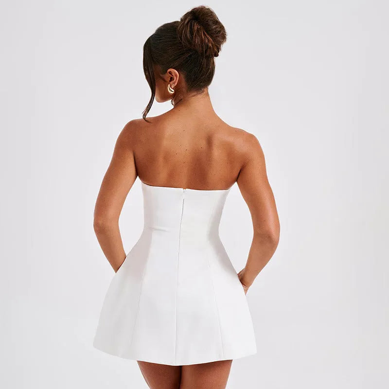 Solid colour backless tube dress with short A-line skirt on a hanger.