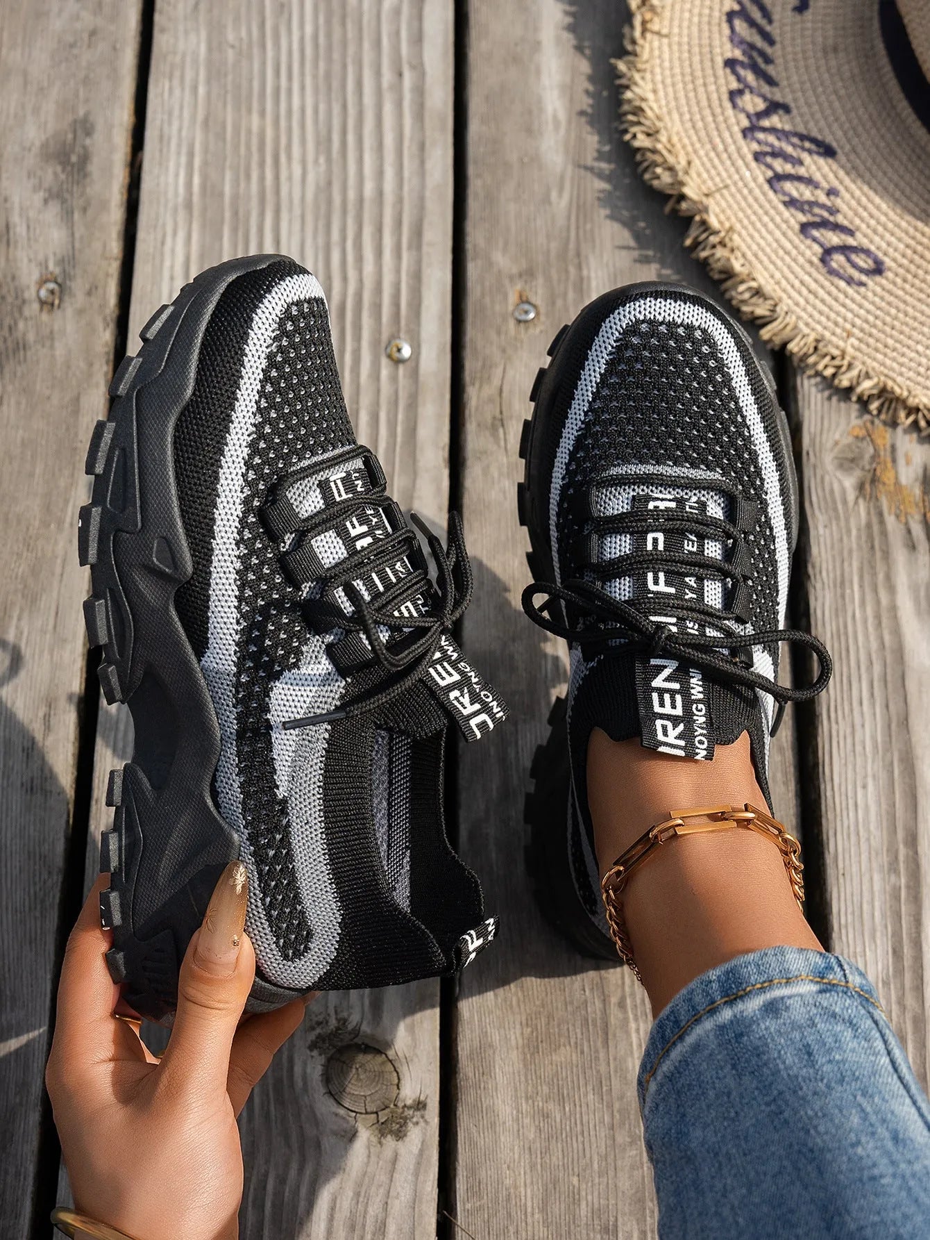 Women's flyknit mesh sneakers with rubber sole and lace-up design in black and gray