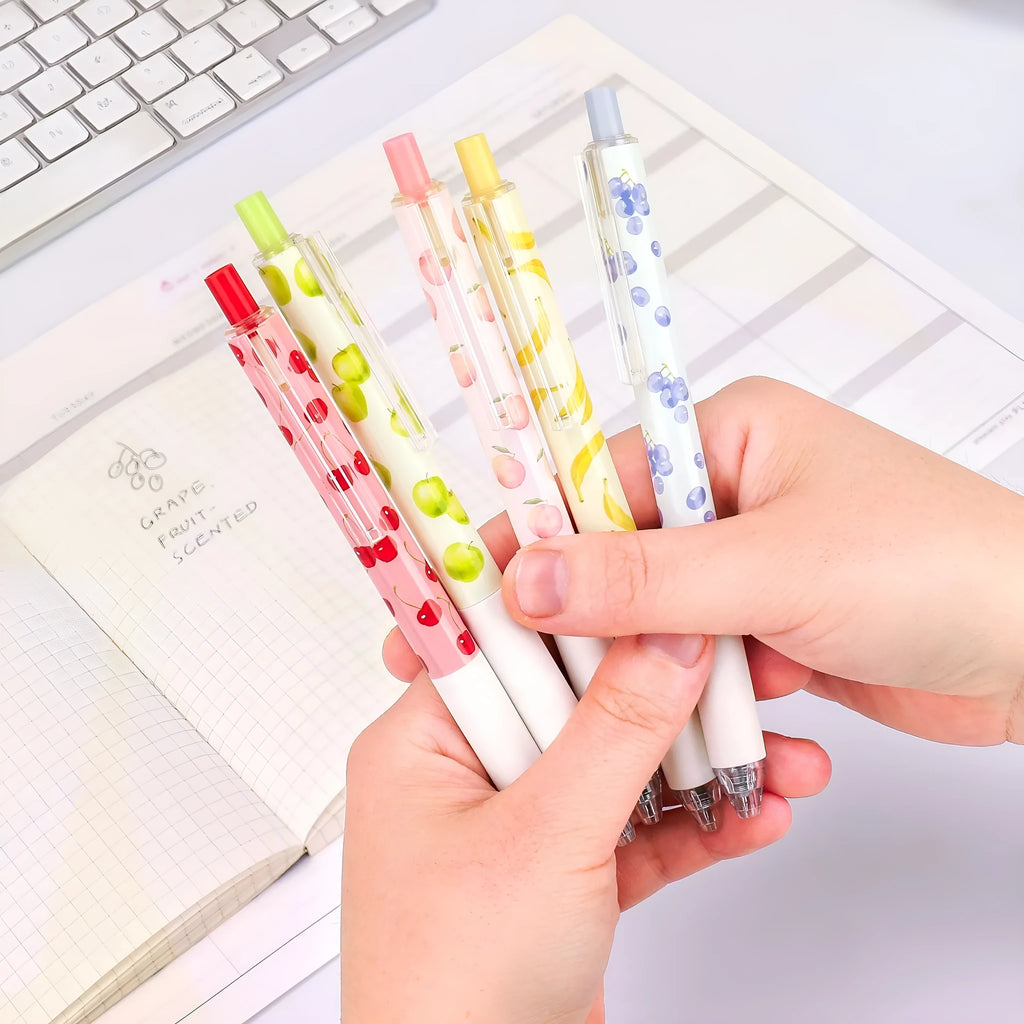 Three fruit scented press-action pens with 0.5mm tips and black ink refills