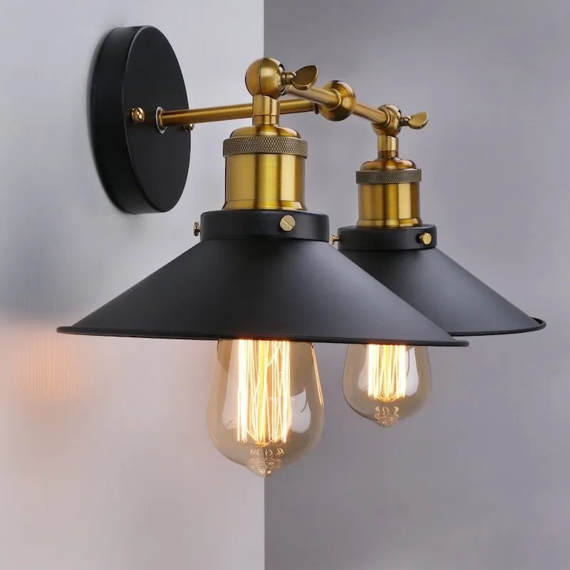 Black double head American retro industrial style iron wall lamp mounted on a wall.