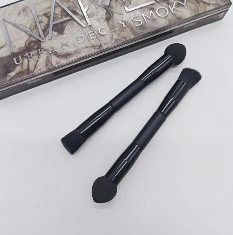 Elegant black double-headed makeup brush with a miter sponge and concealer brush on a wooden handle