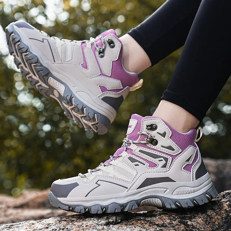 High-top hiking sneakers in multiple colours with flannel uppers and rubber soles on a rocky path.