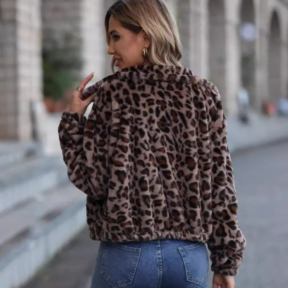 Women's loose-fitting leopard print coat with full zipper and raglan sleeves on a hanger