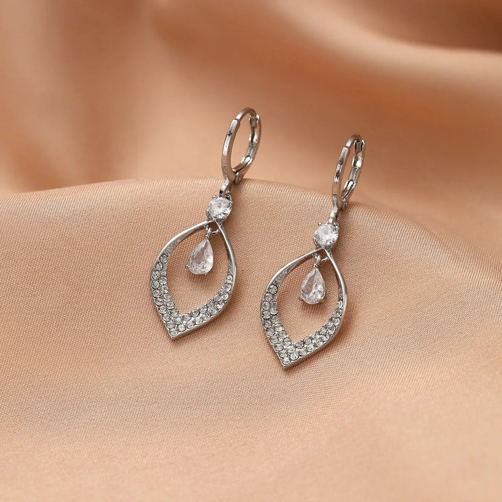 Gold and silver coloured women's teardrop zircon tassel earrings on a copper base.
