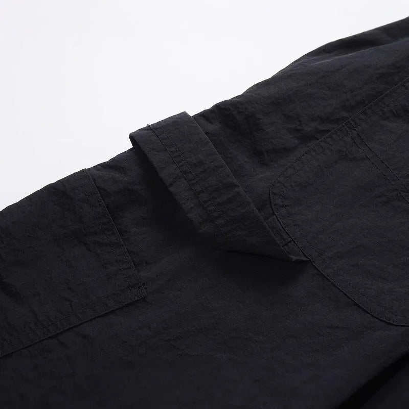 Black men's baggy paratrooper trousers with a drawstring elastic waistband on a plain background.