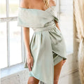 A woman wearing an off-shoulder strapless dress with short sleeves, a high waist, and a patchwork skirt.
