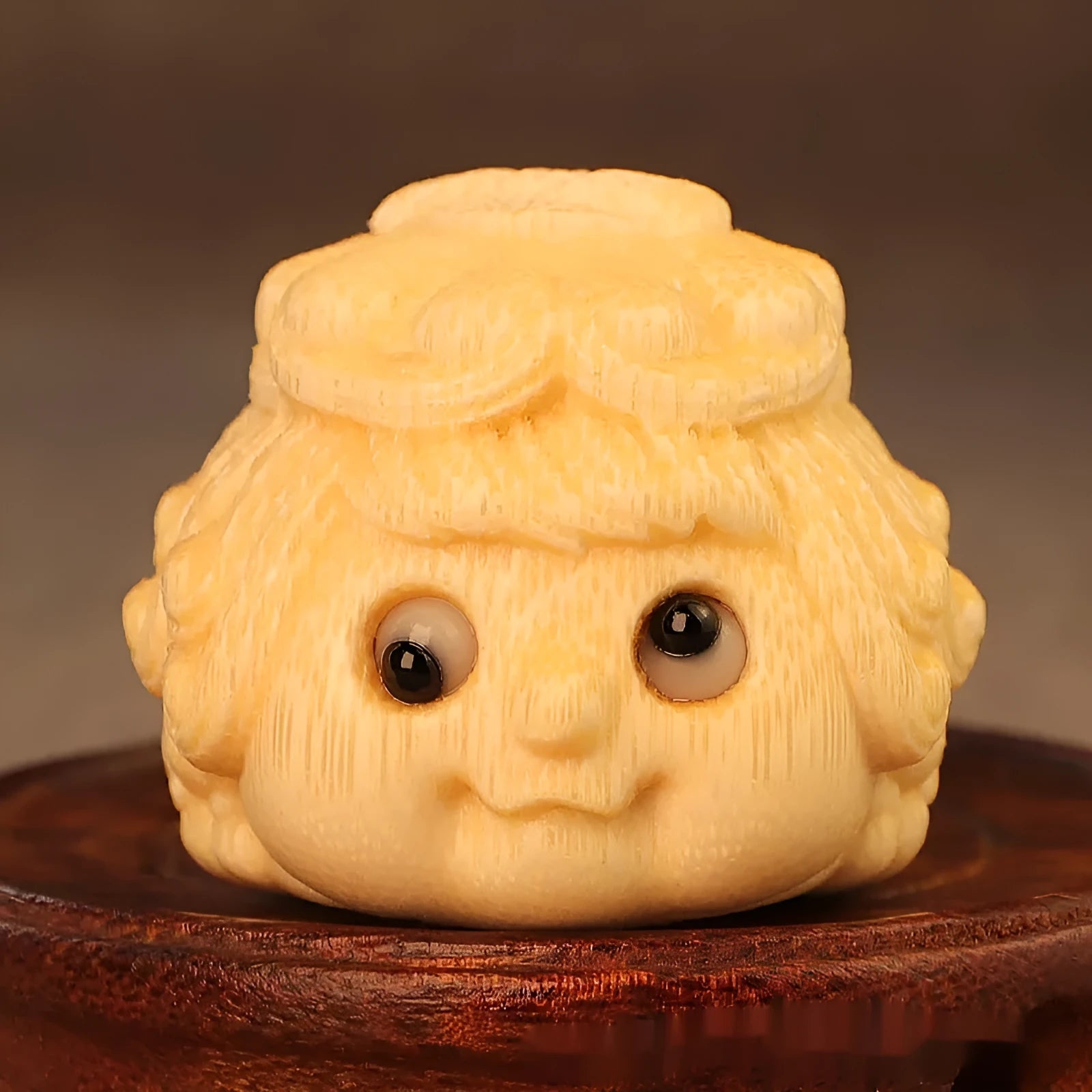 Golden Toad Princess ornament carved from solid bamboo on a wooden surface.
