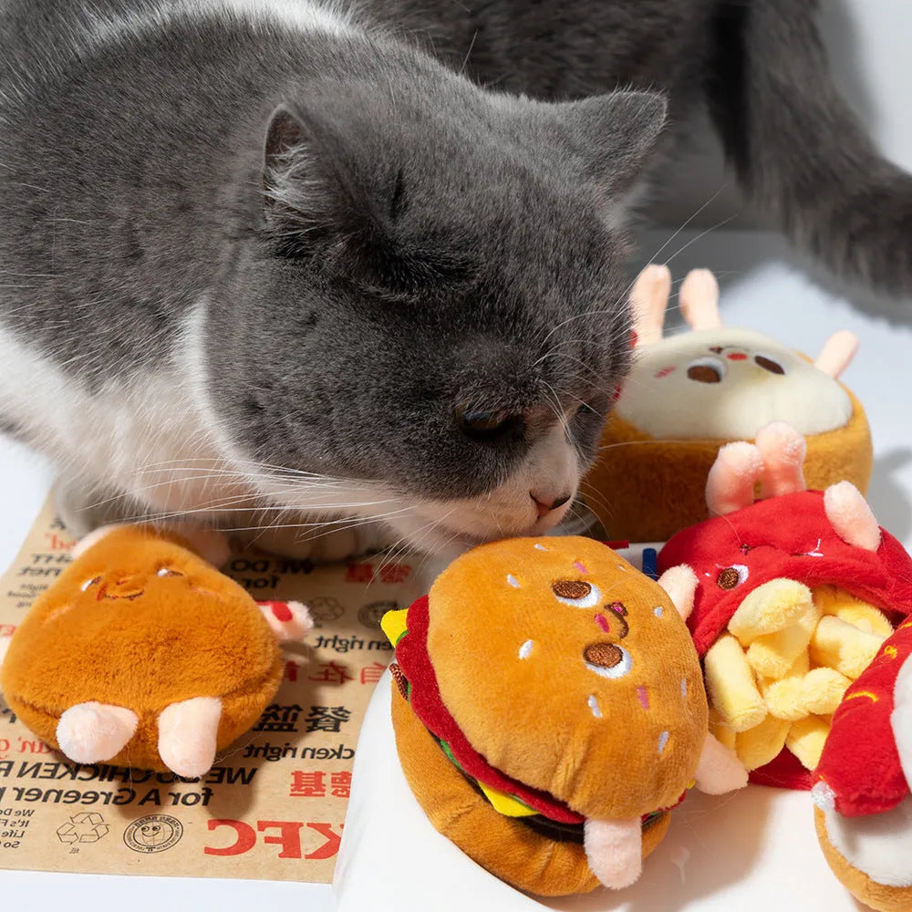 Assortment of kitten teething toys shaped like a hamburger, chicken leg, bread, fries, and hot dog.