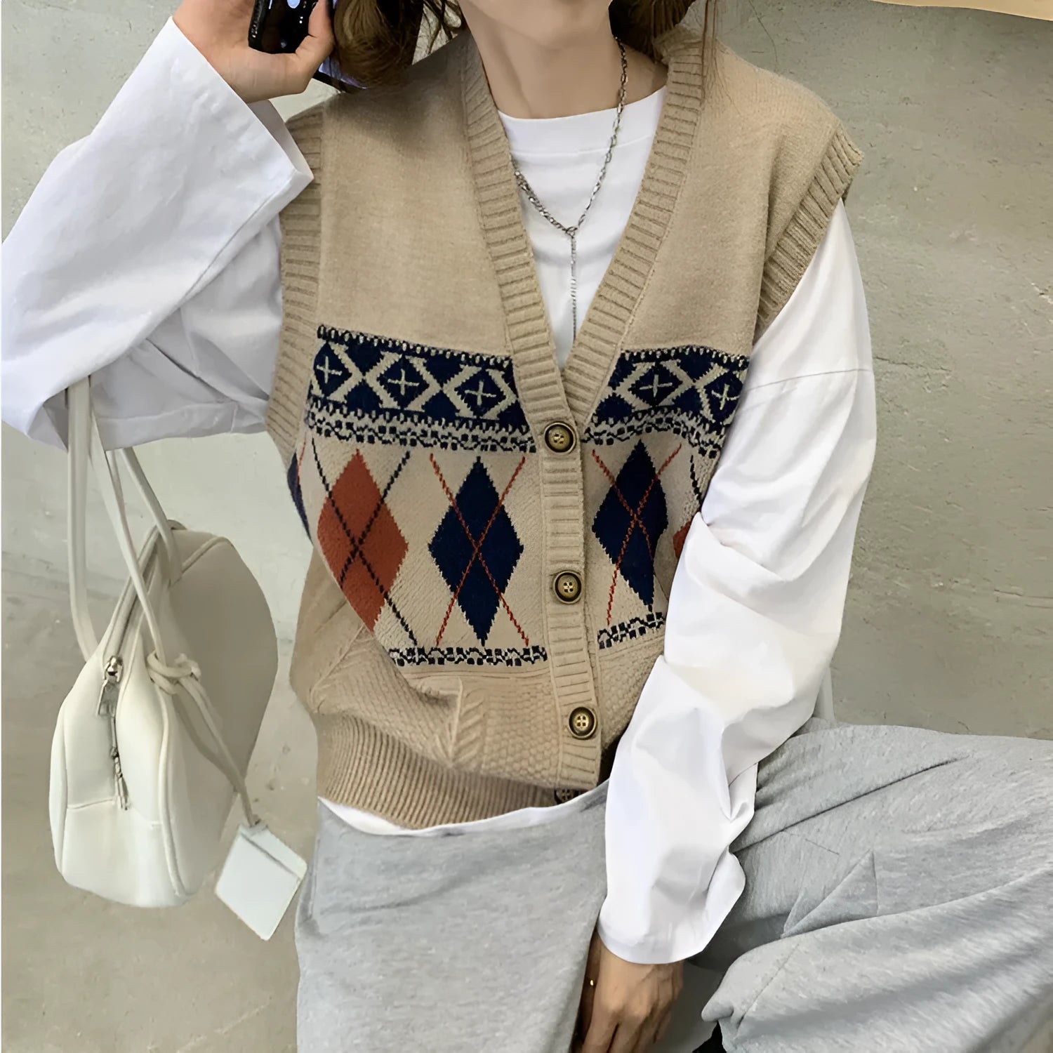Loose sleeveless cardigan top in diamond plaid acrylic knit showing khaki navy blue and red colour options
