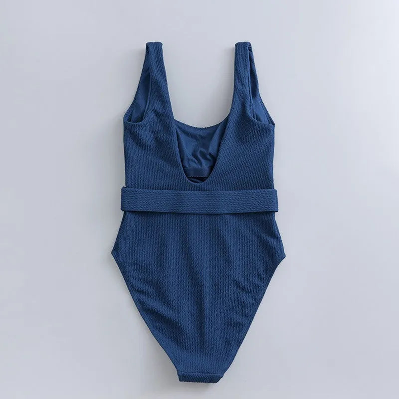 Navy blue women's one-piece swimsuit with triangle design and chest padding on a mannequin.