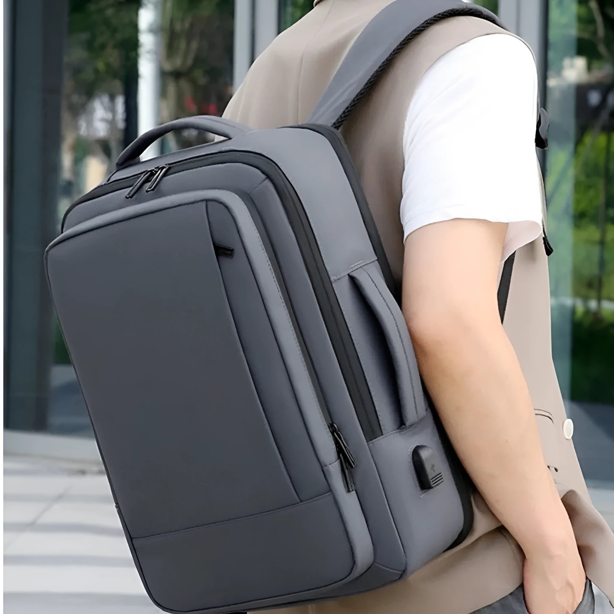 Black waterproof Oxford cloth business backpack with curved shoulder straps and derm leather accents