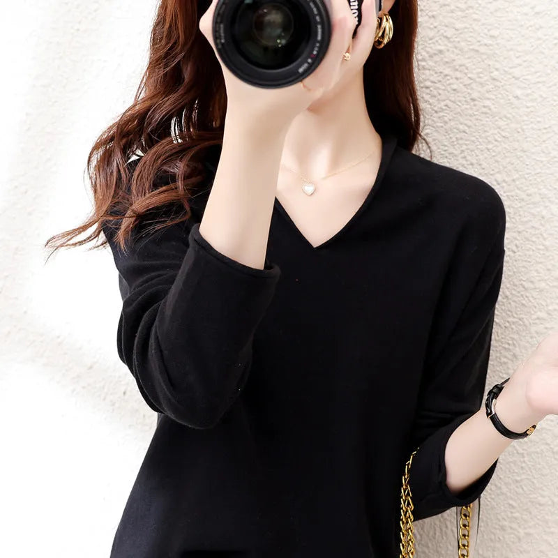 Women's V-neck long sleeve knit top in a macaron colour on a hanger.