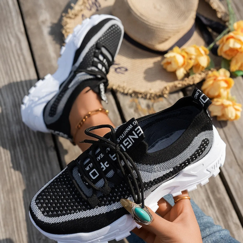 Women's flyknit mesh sneakers with rubber sole and lace-up design in black and gray