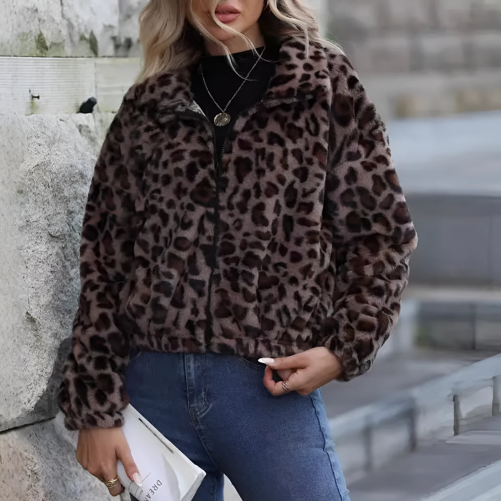 Women's loose-fitting leopard print coat with full zipper and raglan sleeves on a hanger
