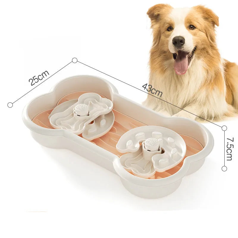 Large green slow feeder dog bowl with wave-pattern trays and suction cups on a wooden floor.