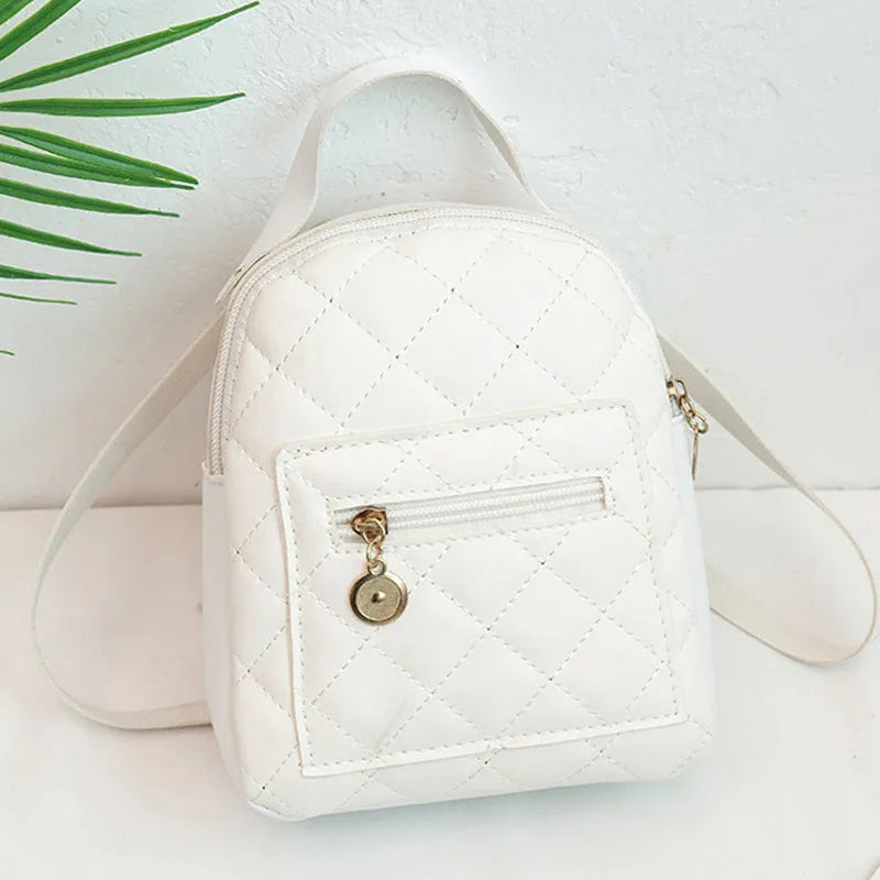 Girls' hard backpack with embroidery in white, black, or pink colours, showing sandwich pocket and soft handle
