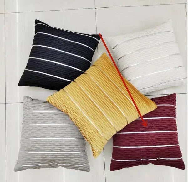 Square striped velvet plush cushion cover in a selection of colours on a sofa.
