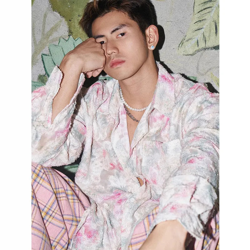 Man wearing a blue floral embossed long sleeve shirt with a loose fit