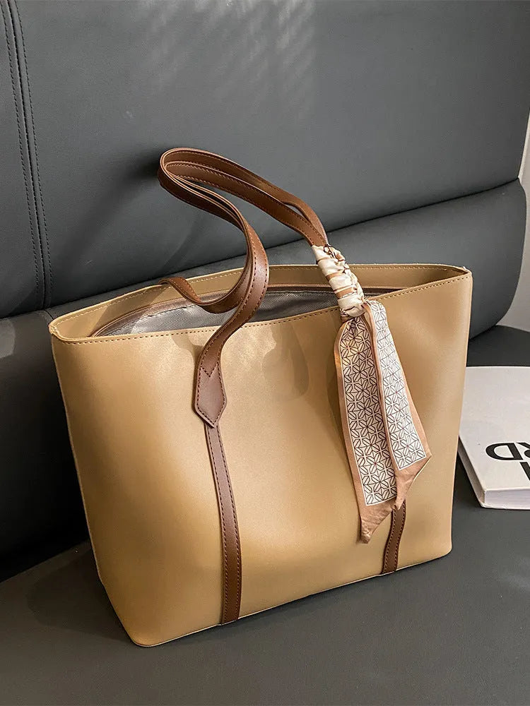 Large soft tote bag in bucket style with crossbody strap and sewing line detailing