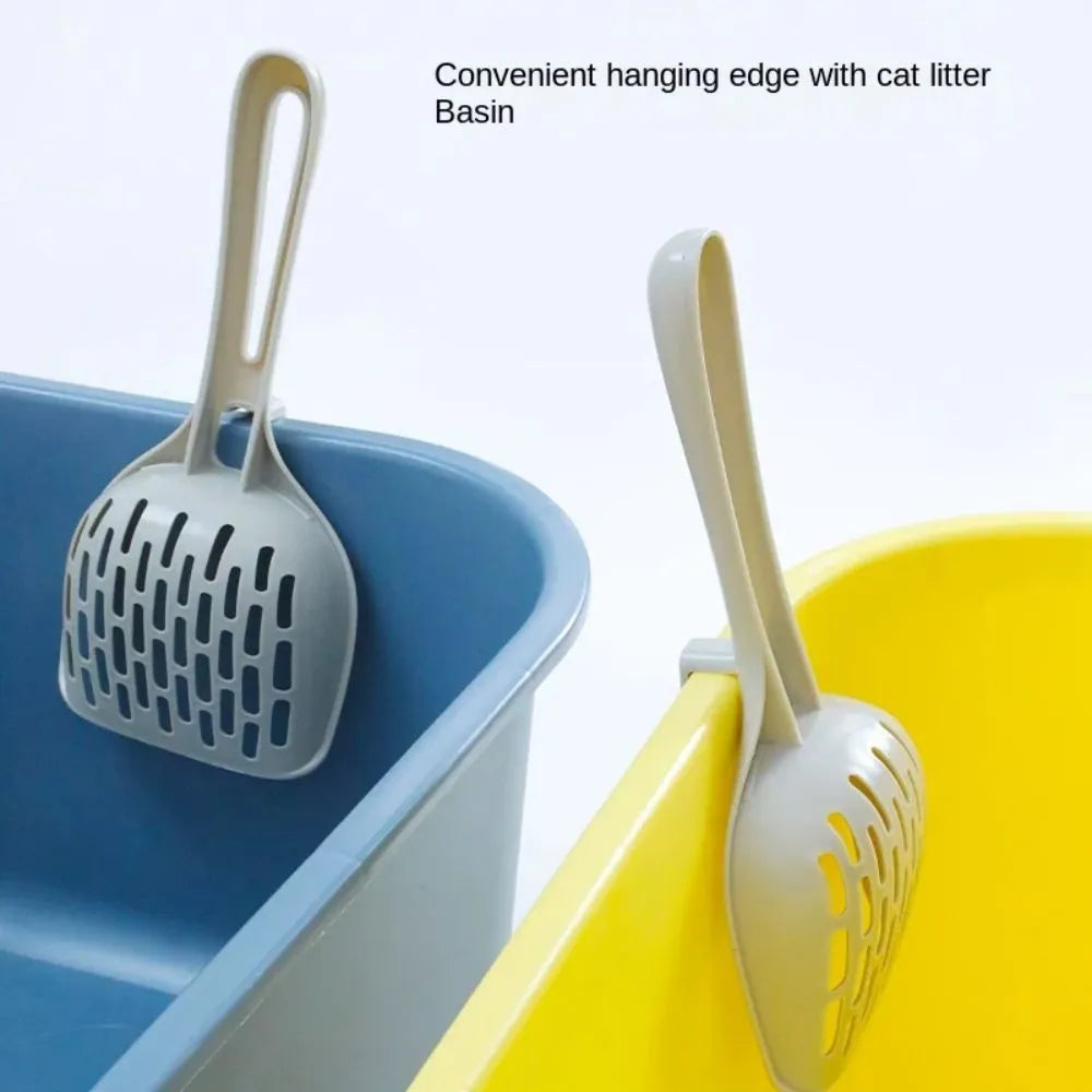 Grey plastic cat litter scoop with drainage holes resting on matching base unit