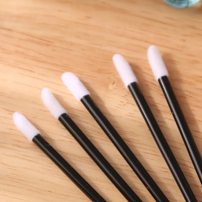 Pack of multi-colour disposable lip brush applicators with black handles and soft flocked tips.