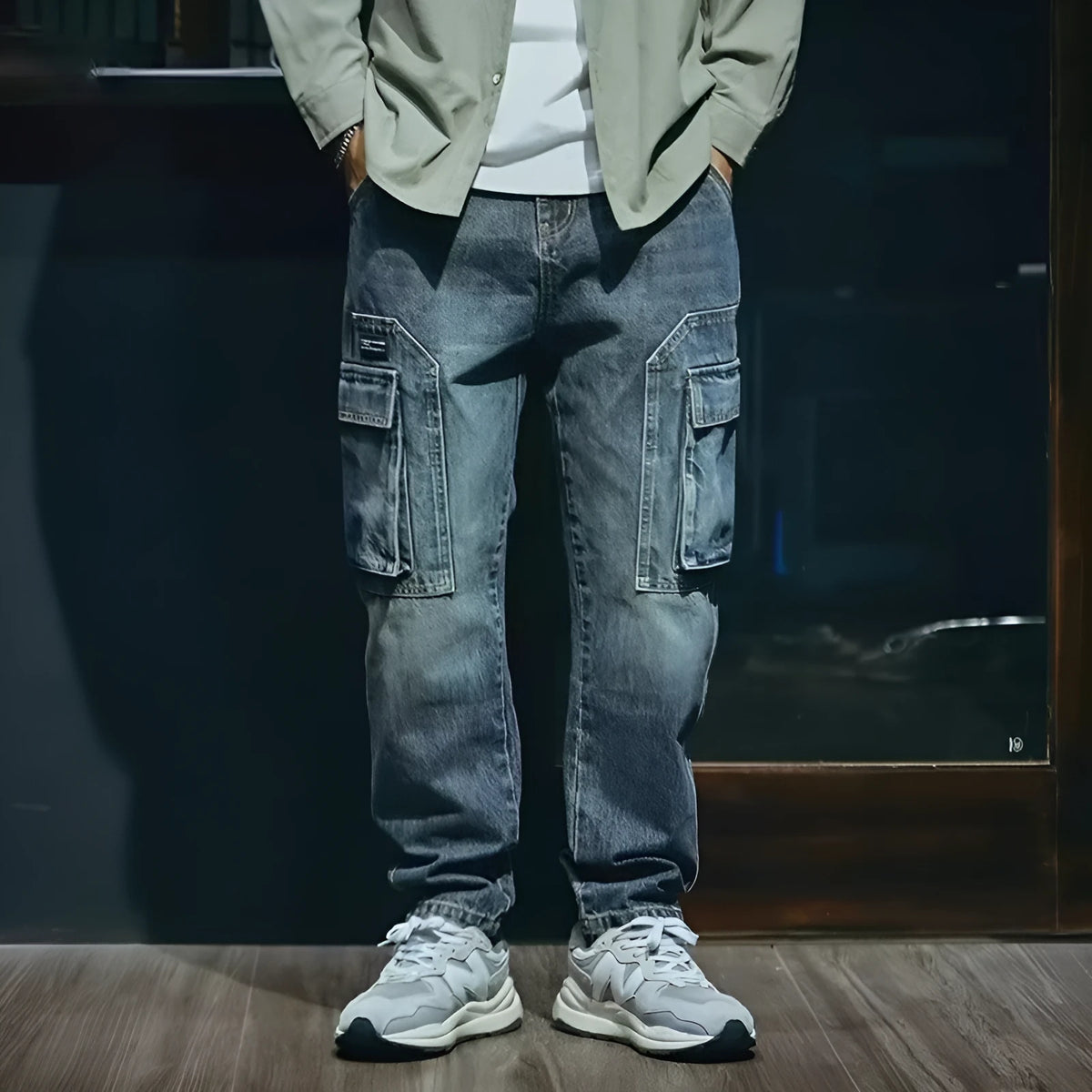Blue men's loose straight-leg retro-style stretch denim trousers on a plain background.