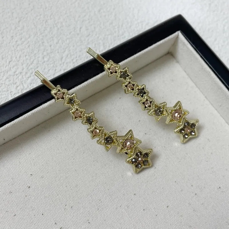 Gold electroplated hair barrette with star decoration and side clip design for bangs